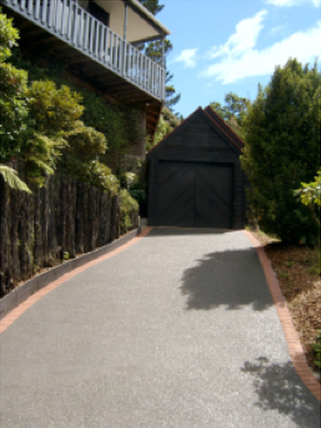 New brick-edged driveway with a black timber edge